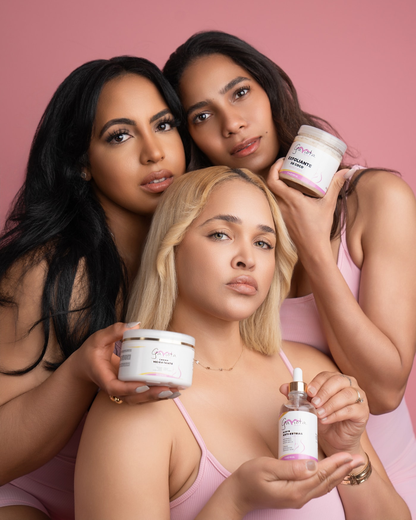 Three women holding Gaviota by Lia body-care products