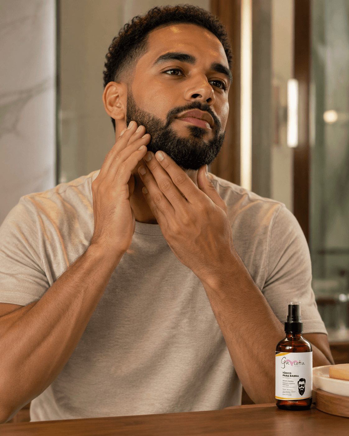 Man applying Gaviota by Lia Beard Tonic in front of the mirror